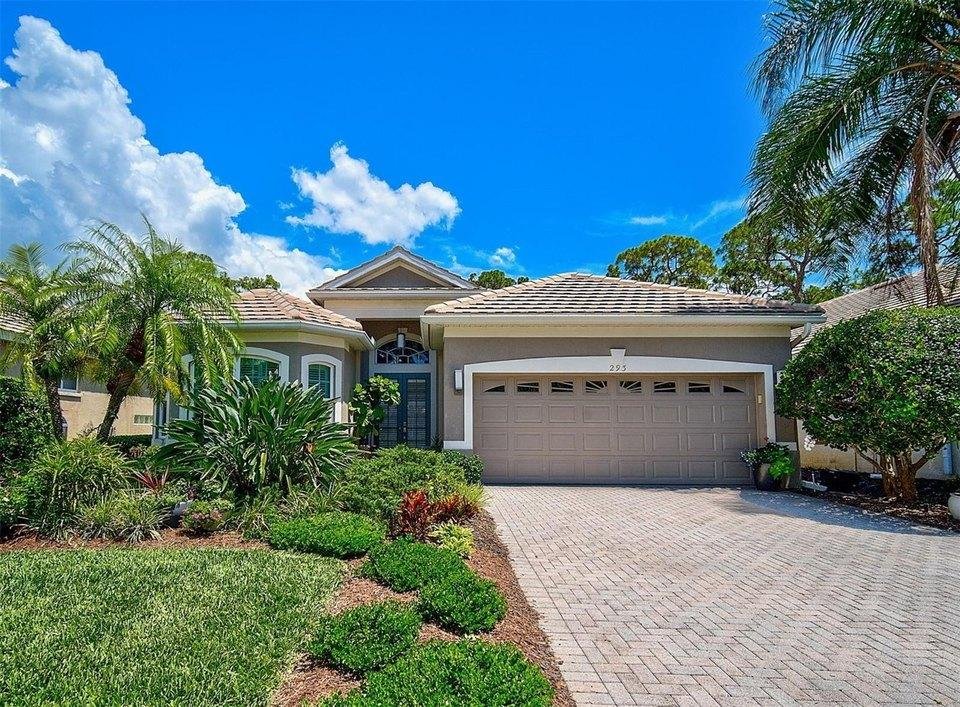 exterior of a well-maintained Florida home, including its roofline, windows, gutters, and landscaping.